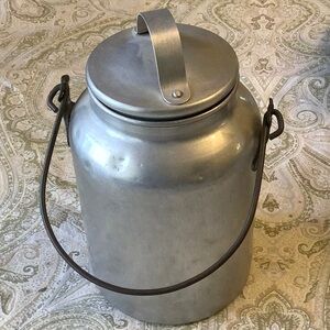 Lovely antique metal milk container. 9”x6”. Has removable lid. Lightweight.